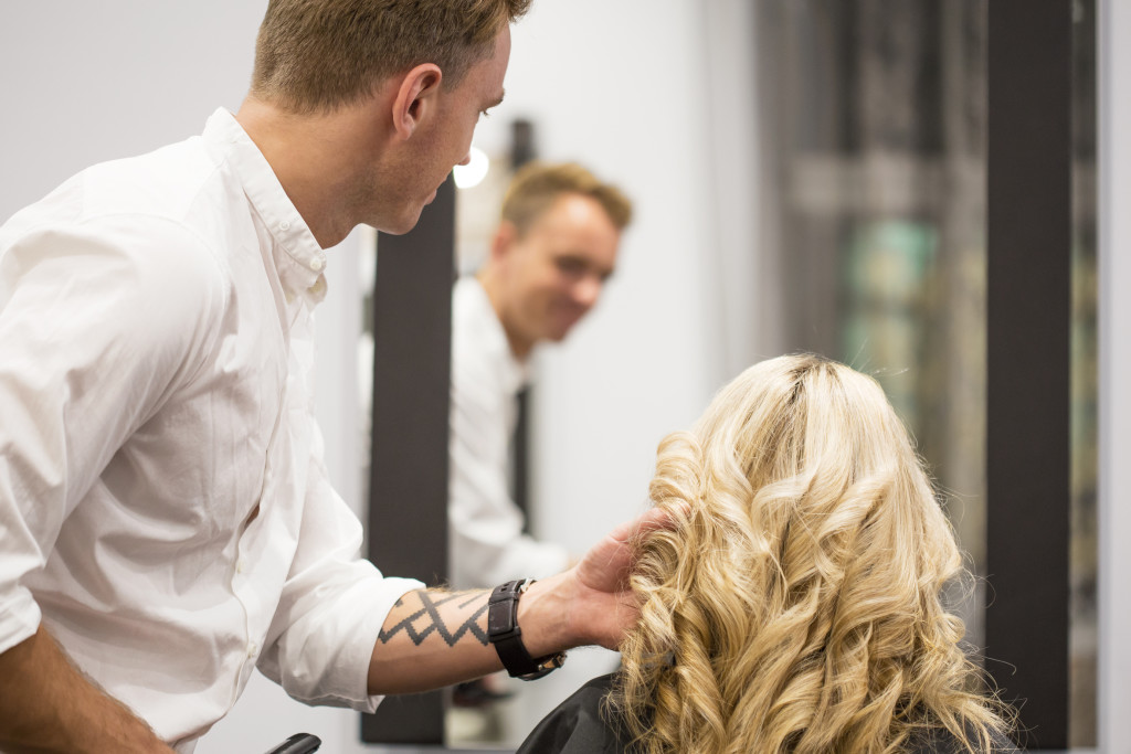 Hairdresser styling woman's hair